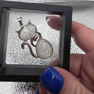 cat-shaped necklace featuring a natural white crystal